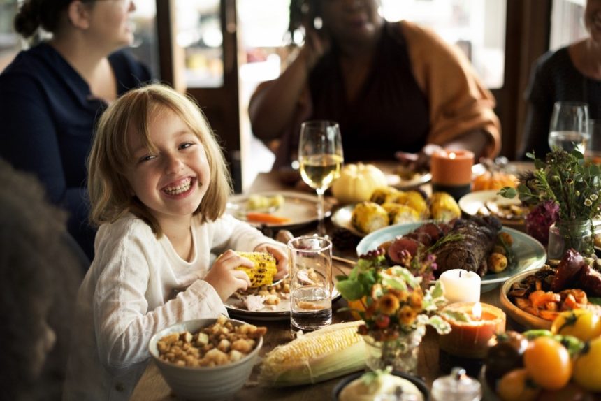 Young girl at a huge Thanksgiving dinner