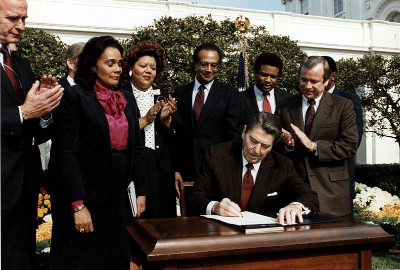 Ronald Reagan signing a law establishing Martin Luther King Jr.'s birthday as a national holiday.