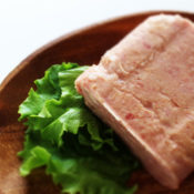 Delicious chunk of spam on a wooden plate