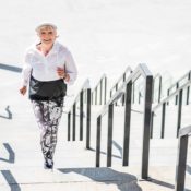 Elderly woman running up a set of stairs during a jog