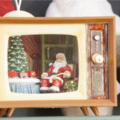 A small santa doll inside a toy TV