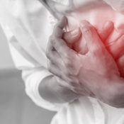 A man clutching his chest as if he is having a heart attack.