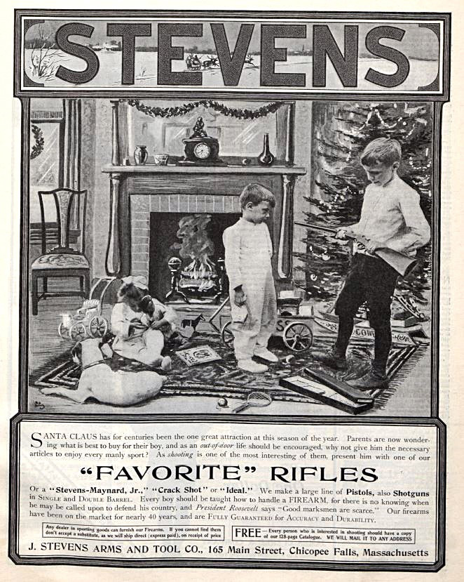 A young boy holds a rifle he got for Christmas under the tree while his younger brother looks on