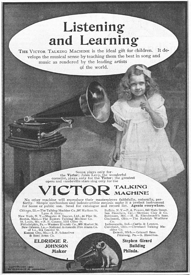 Little girl standing next to a vintage Victor record player