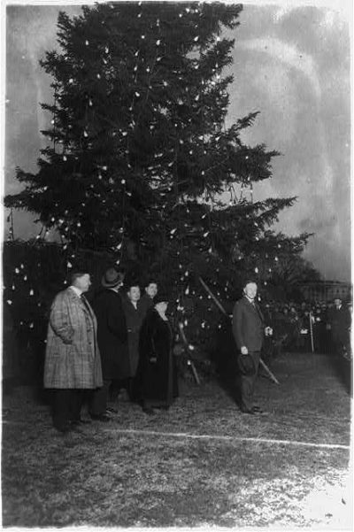 United States president Calvin Coolidge and his staff lights the first National Christmas Tree.