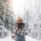 Woman enjoying a walk in a snowy wood