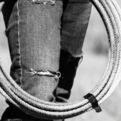 A young cowgirl holding a lasso