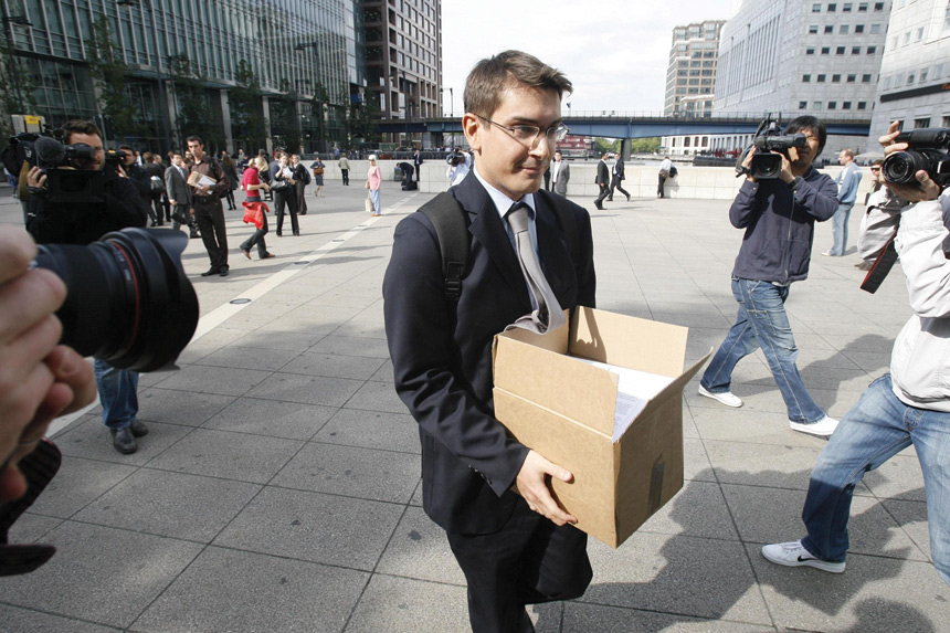 A terminated Lehman Brothers employee in London carries his belongings following the company's bankruptcy in September, 2008.