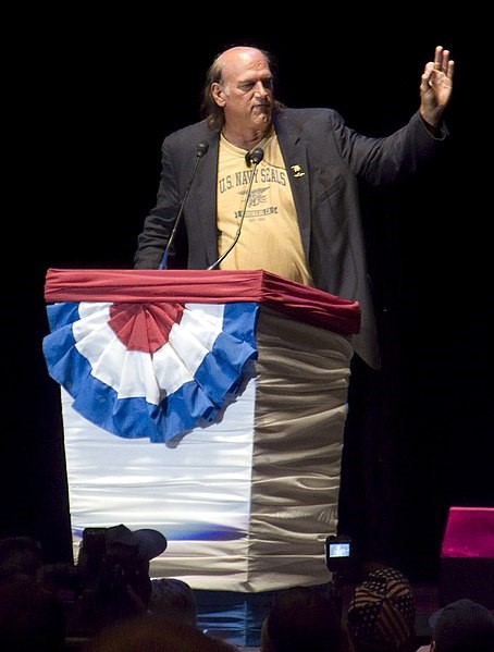 Jesse Ventura speaking behind a podium