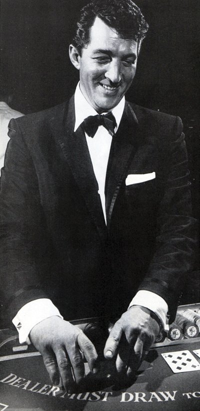 Singer Dean Martin dealing cards at a blackjack table.