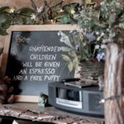 Small chalkboard sign on a counter that reads "Unattended children will be given espresso and a free puppy"