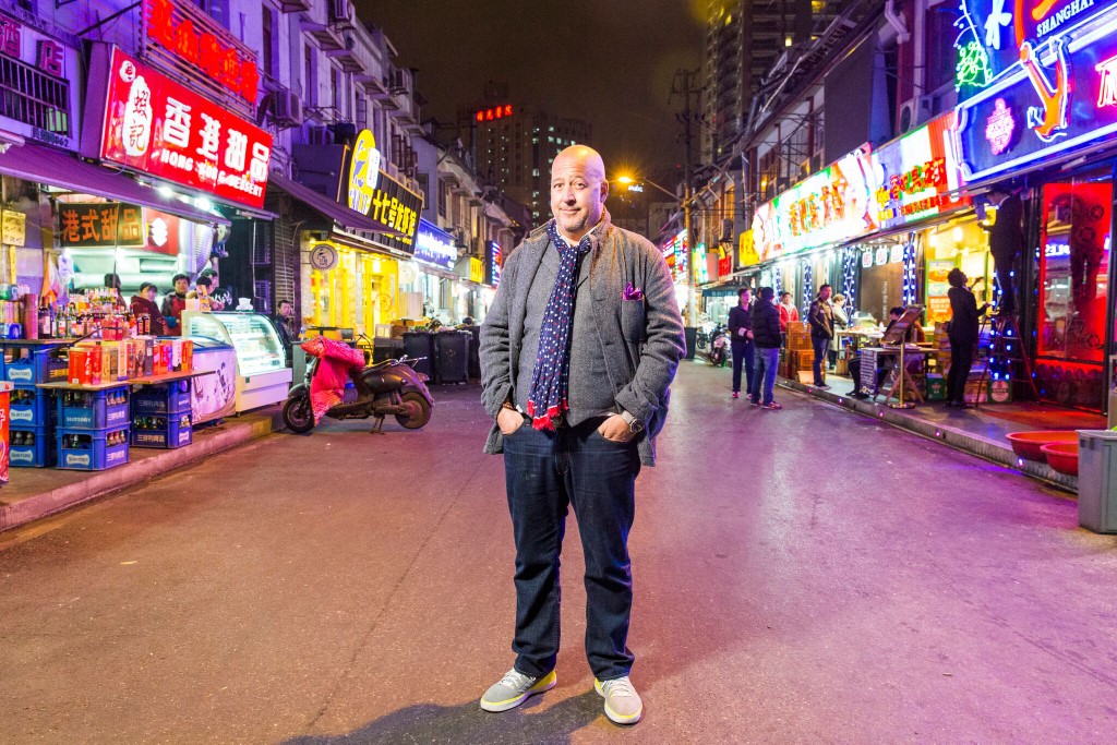 Andrew Zimmern stands in a Shanghai street.