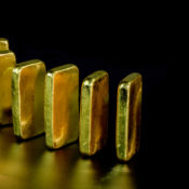 Gold ingots set upright in a row.