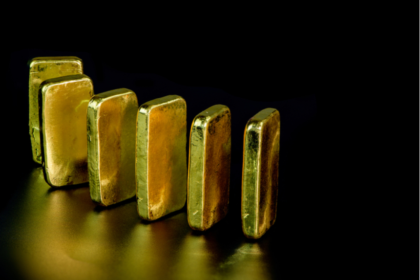 Gold ingots set upright in a row.