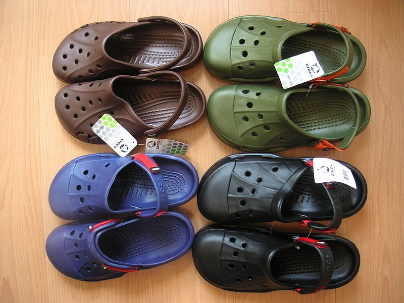 Four pairs of crocs footwear in a variety of colors.