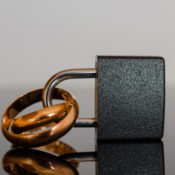 Wedding rings stuck in a padlock.