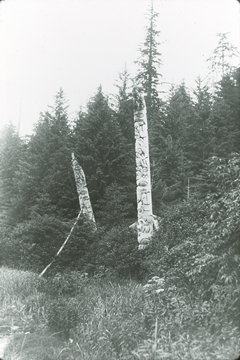 A totem pole in a wooden area in Alaska