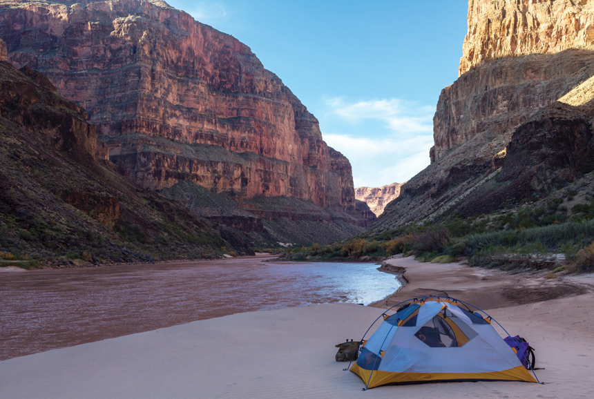Camping tent on the shores of the Colorado River, at the bottom of the Grand Canyon.