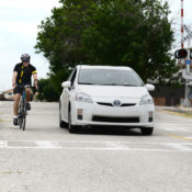 Motorist keeping their car about 3 feet away from a cyclist as he passes by their passenger side.