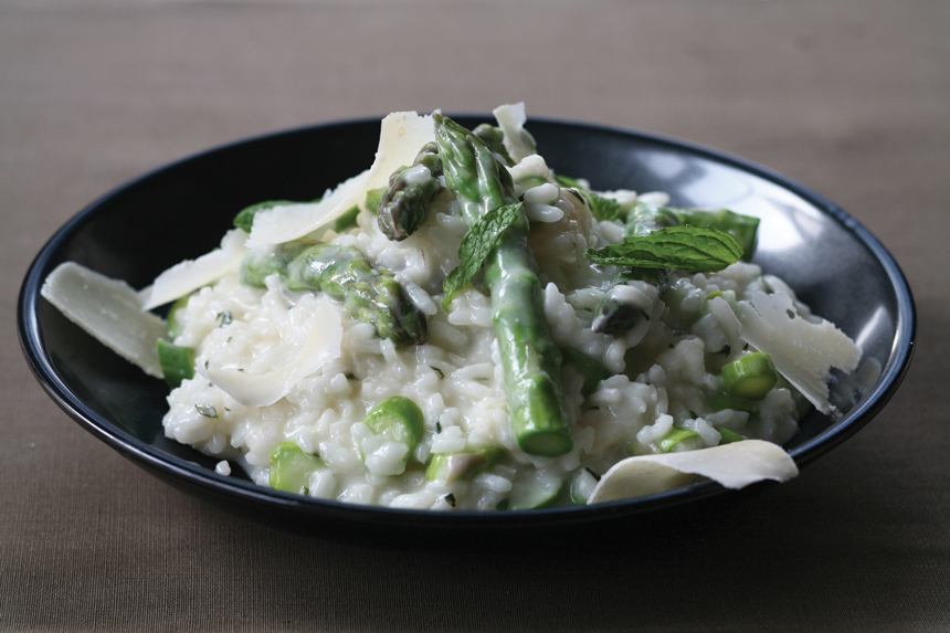 Bowl of risotto with asparagus and melted parmesan cheese