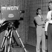An interview occurs on set for the DuMont television network.