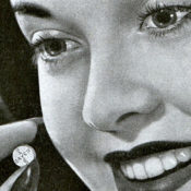 Close-up of a woman talking an aspirin pill
