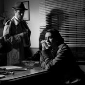 Noir scene with a detective and a distraught client.
