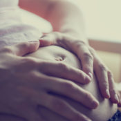 Close-up of a pregnant woman with her hands on her belly