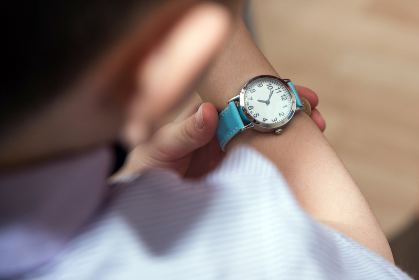 Boy looking at his wristwatch