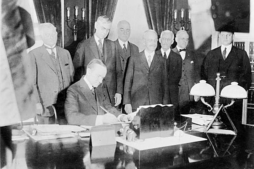 Calvin Coolidge signing a bill