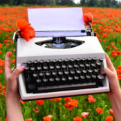 Woman holding a typewriter in a flower field