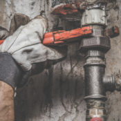 Plumber turning a bolt on a sink pimp