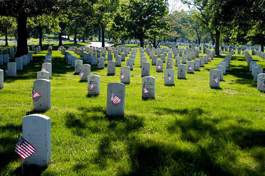 Graves at Arlington National Cemetery, with U.S. flags.