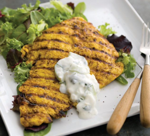 Grilled chicken with turmeric spice rub and baby greens.