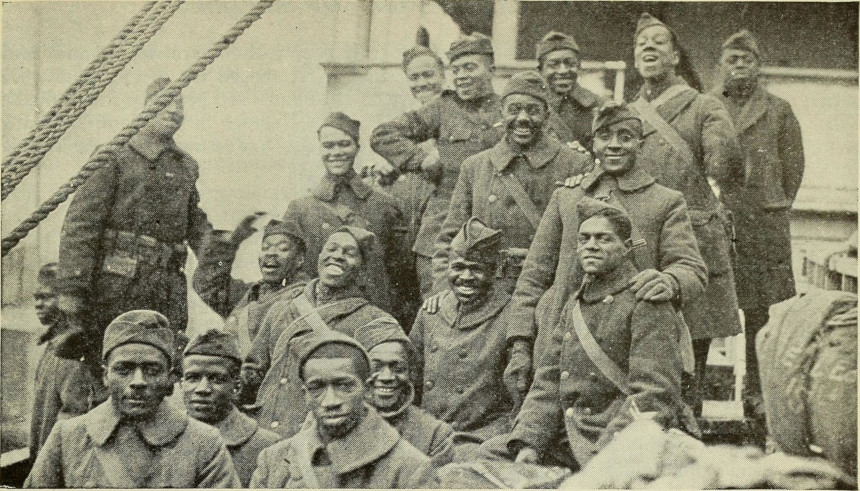 African-American and African-Puerto Rican soldiers smile for a group photo during World War I