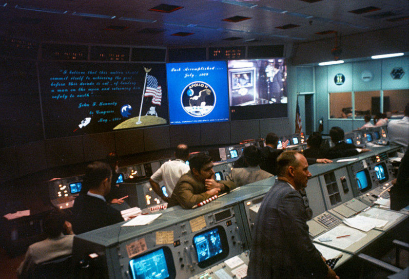 Mission Control at Houston, Texas at the end of the Apollo 11. Nixon can be seen greeting Lance Armstrong, Buzz Aldrin, and Michael Collins on a screen at the back of the room.