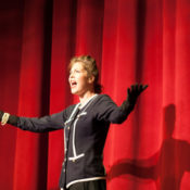 Woman on stage acting.