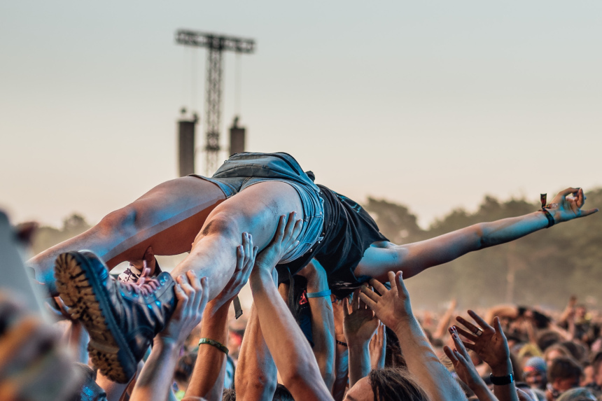 Woman crowdsurfing during a rock concert