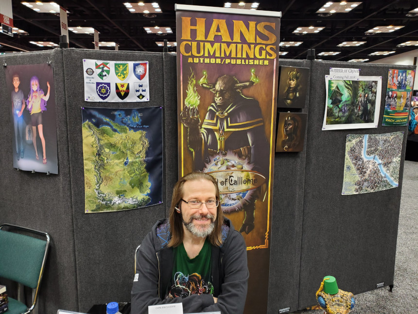 Fantasy author Hans Cummings at a booth during Gen Con 2019.