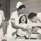 A scared young girl is given a polio vaccine.