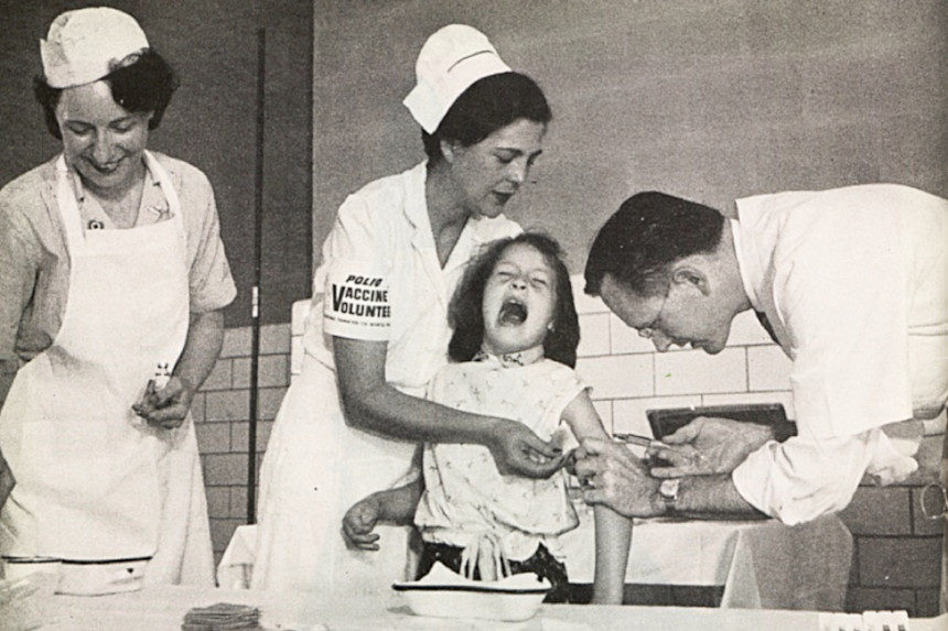 A scared young girl is given a polio vaccine.