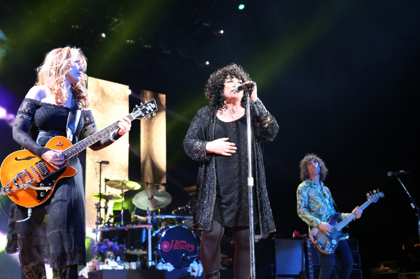 Ann and Nancy Wilson perform together on stage.