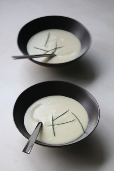 Bowls of potato soup with strips of green onion