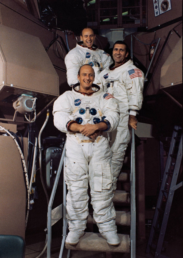 Apollo 12 astronauts pose outside a Command Module simulator