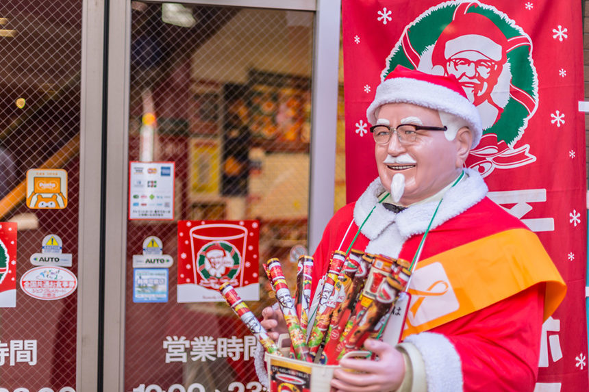 A festive statue of KFC founder, colonel Sanders, outside of an Osaka, Japan restaurant.