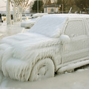 A SUV completely covered in ice.