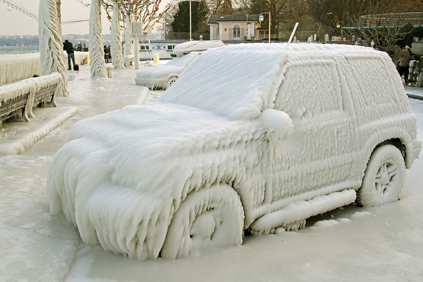 A SUV completely covered in ice.