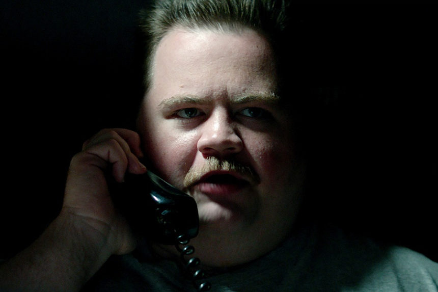 A scene from the Clint Eastwood-directed film, "Richard Jewell." In this image, Jewell, played by Paul Walter Hauser, speaks into a telephone.