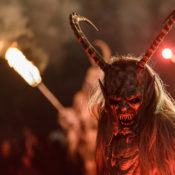 Person dressed up as a devil during a festival.