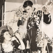 Old, vintage-style photo of revelers at a New Year's Eve parter.